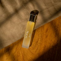 900Y by Tsar 20 ml perfume bottle styled on fabric and wooden surface with warm natural lighting